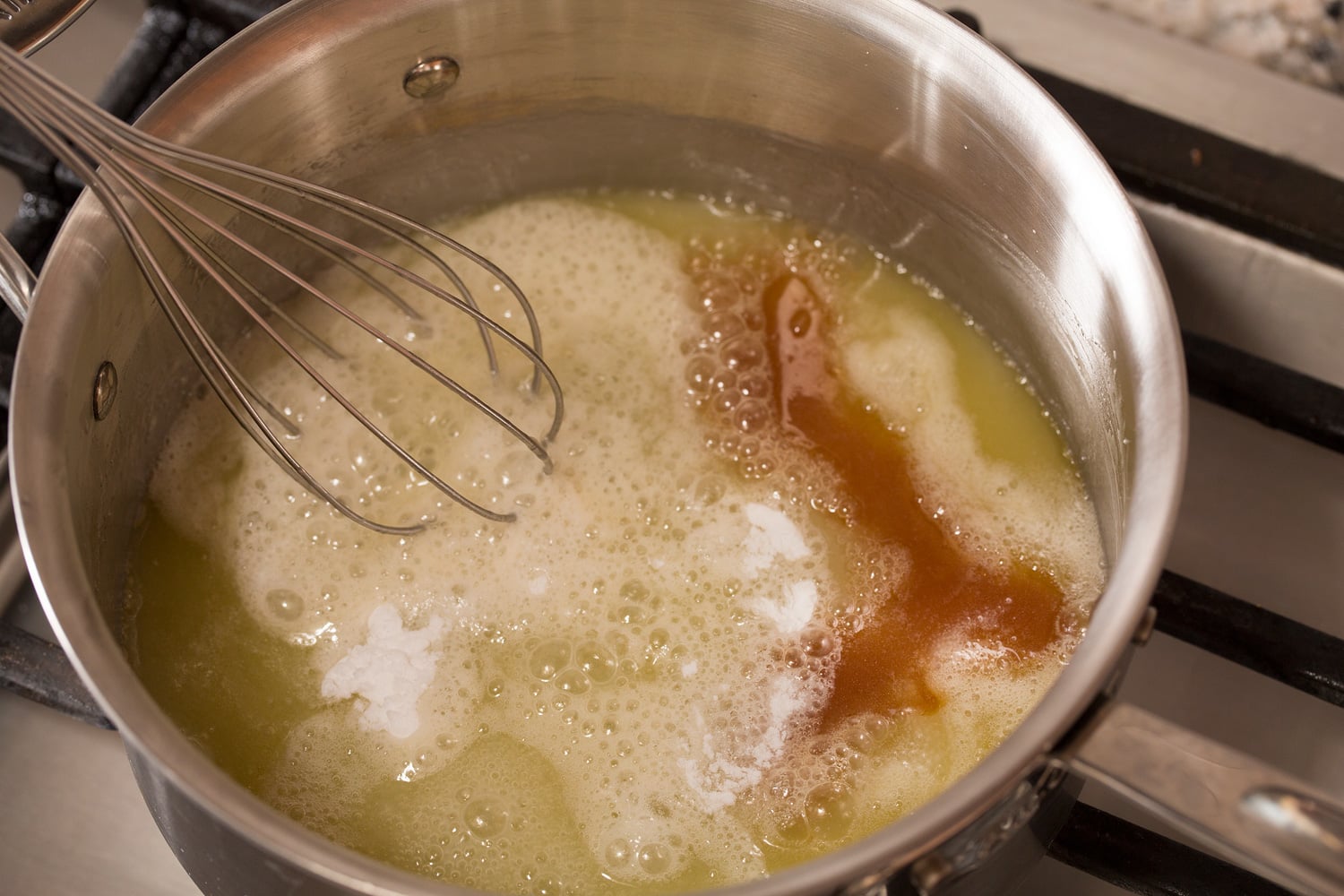 Baking soda and vanilla being added to syrup.