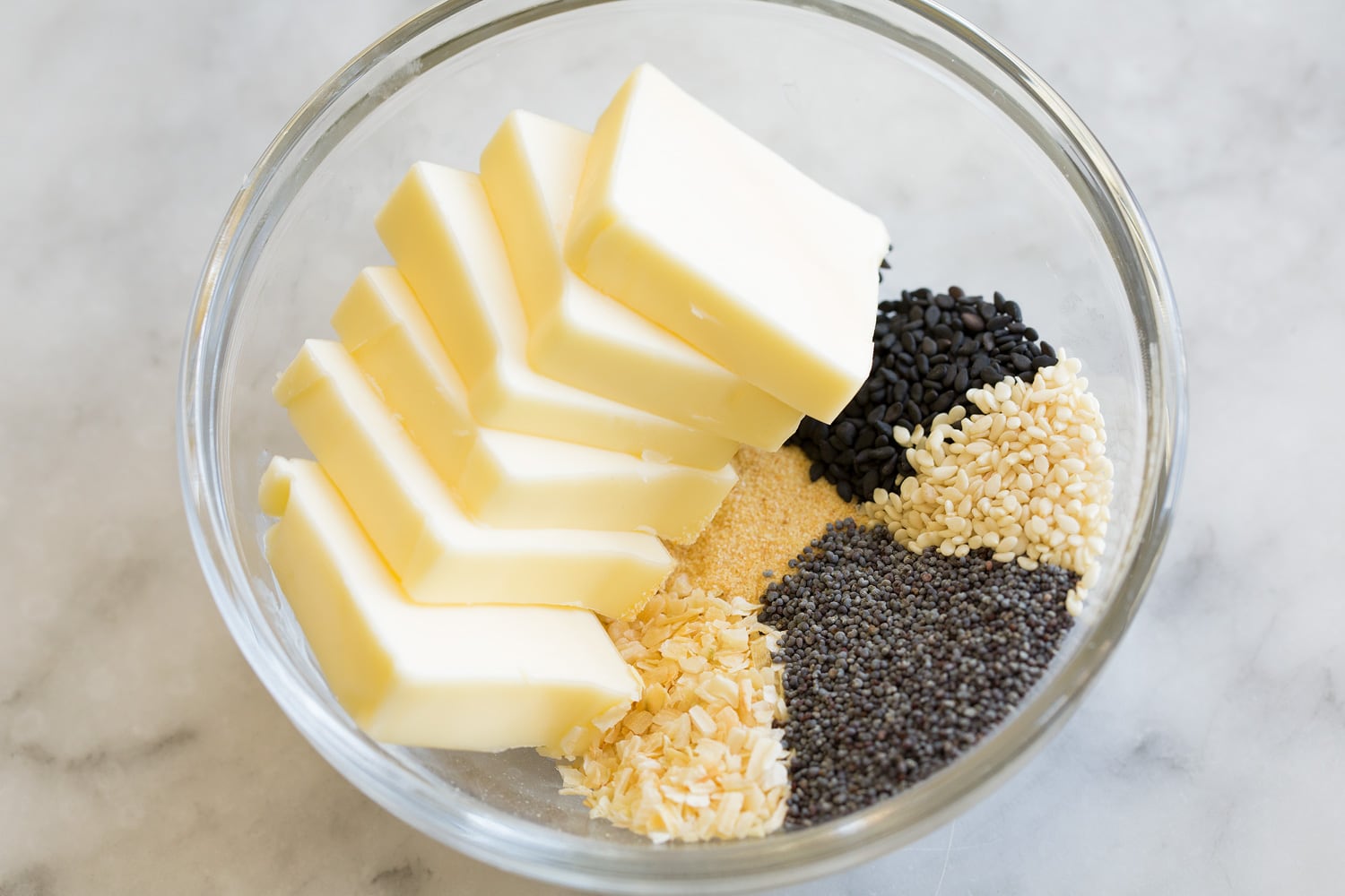 Making butter poppy seed mixture in glass mixing bowl.