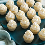 Tray with lots of mini cupcakes with swirled frosting on top.