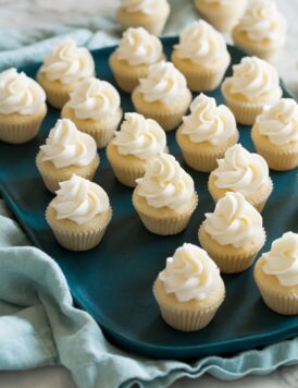 Tray with lots of mini cupcakes with swirled frosting on top.