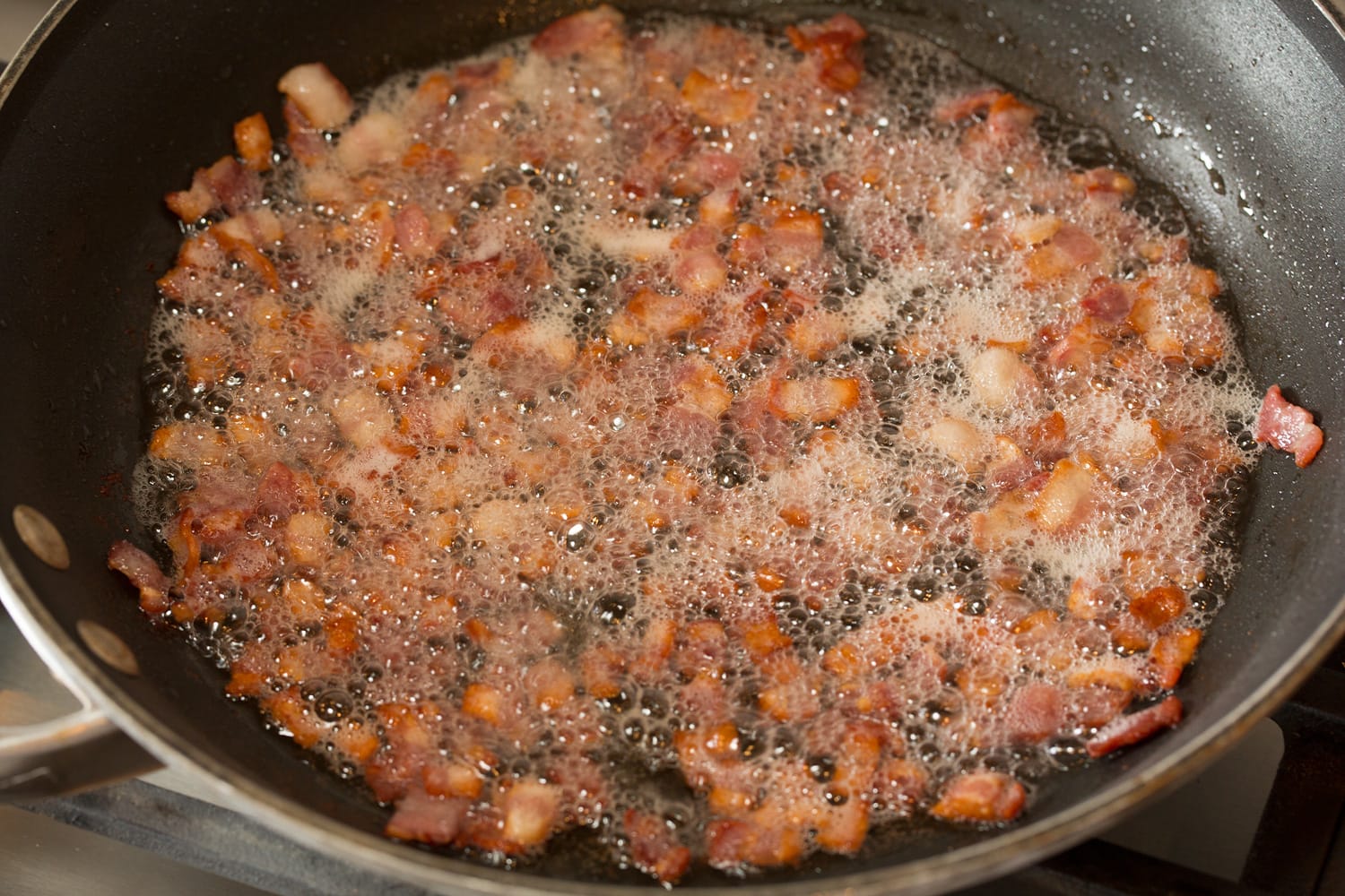 Cooking bacon in a skillet.