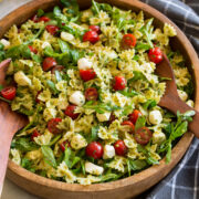 Pesto pasta salad with homemade pesto, baby arugula, grape tomatoes and fresh mozzarella pearls.