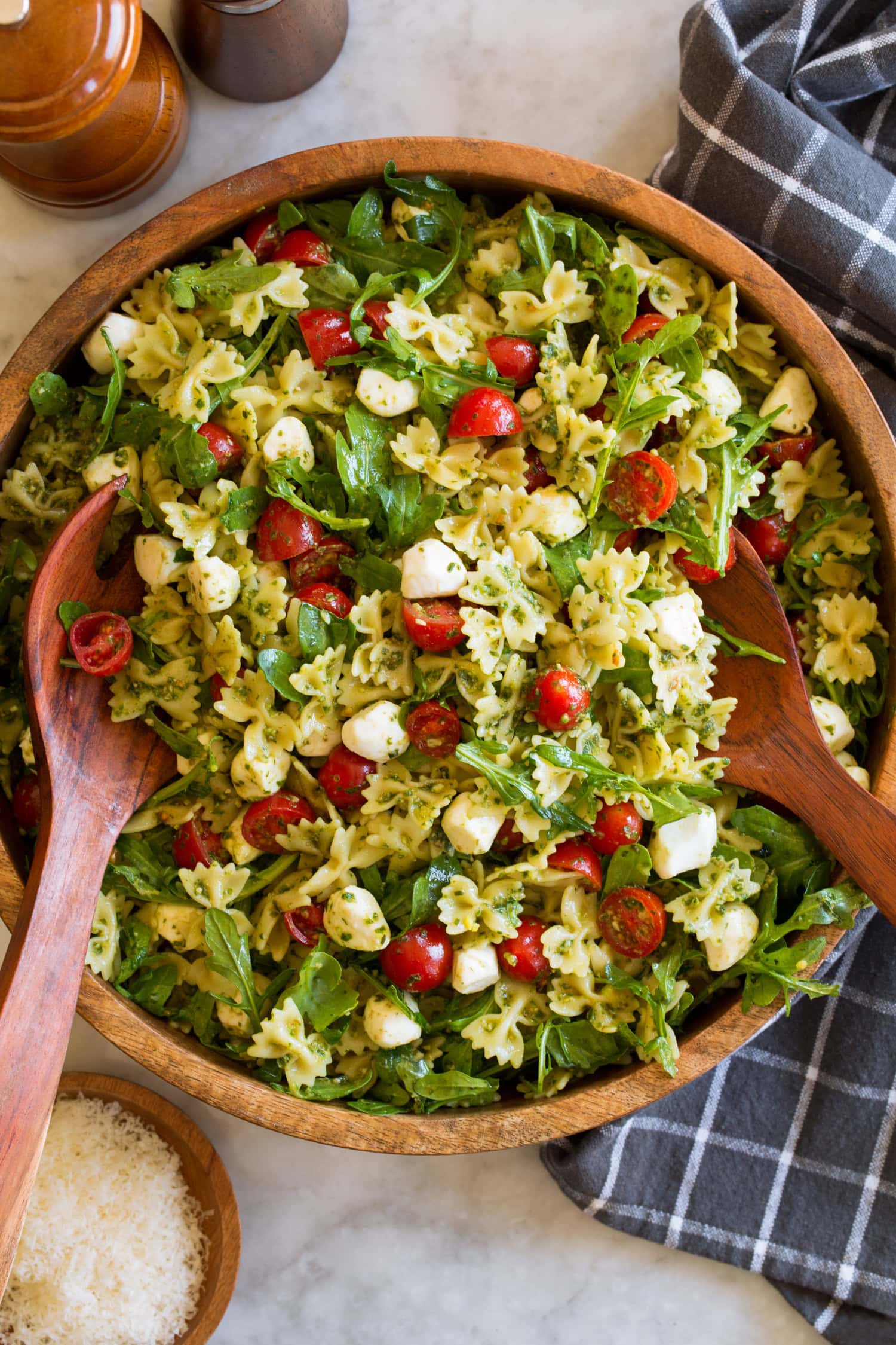 Overhead photo of pesto pasta salad in a wood serving bowl.